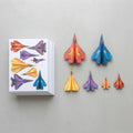 Printed paper fighter jets spread in a fan