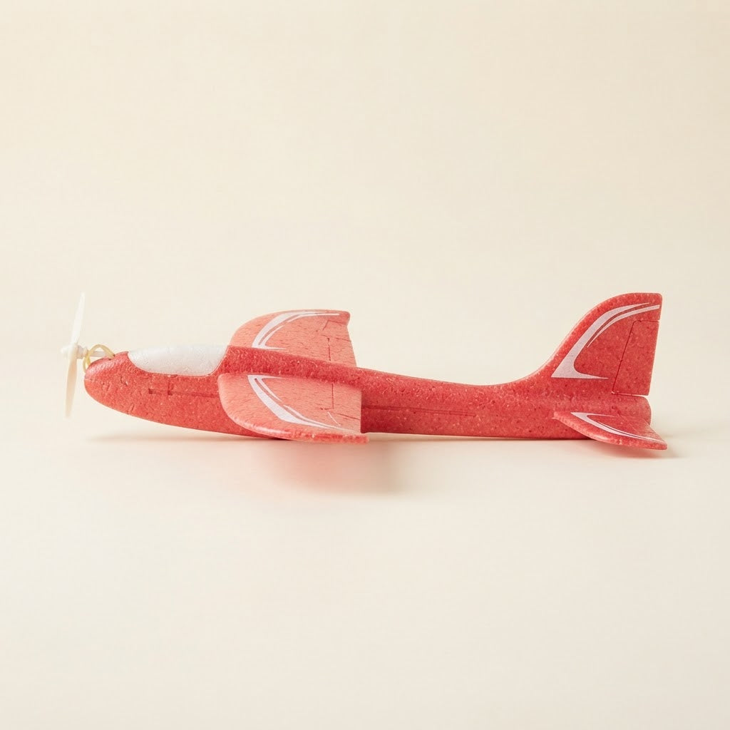 Child winding the propeller of a foam glider plane