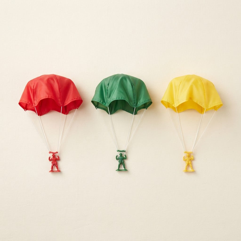 Three toy parachutes in red green and yellow together